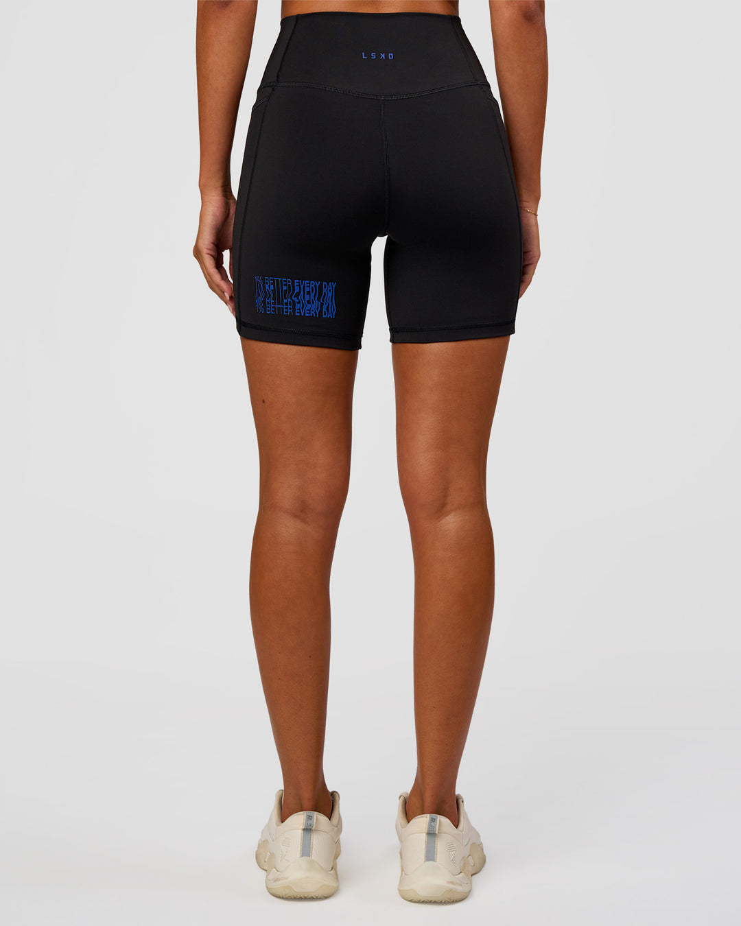 Woman wearing Fusion Hype Graphic Ultra High-Rise 6" Short Pockets - Black-Electric Indigo | Model:Charli | Size:XS - view 7