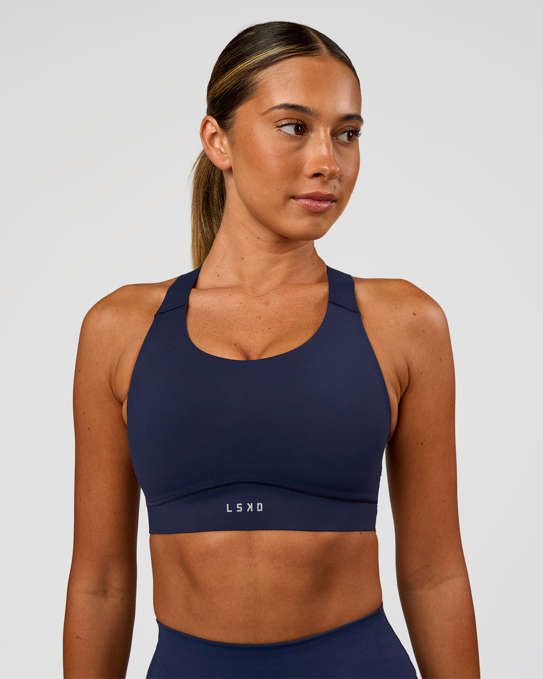 Woman wearing Fusion Sports Bra 2.0 - Future Navy | Model:Charlie | Size:S - view 1