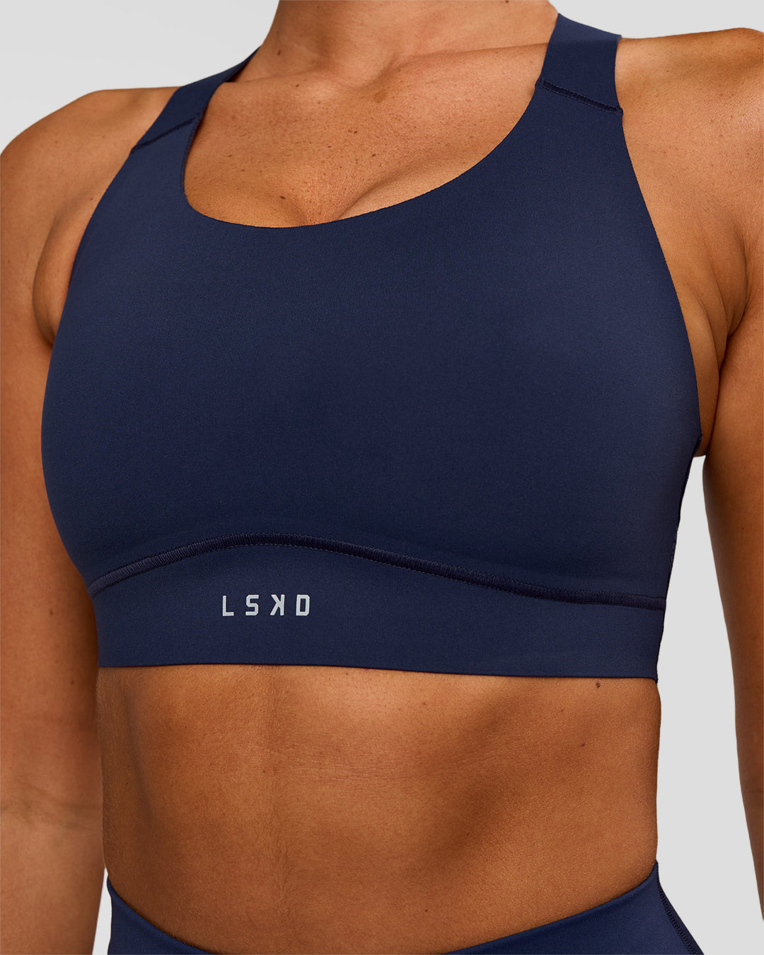 Woman wearing Fusion Sports Bra 2.0 - Future Navy | Model:Charlie | Size:S - view 4