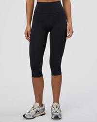 Woman wearing Fusion Ultra High-Rise 3/4 Legging Pockets - Black | Model:Eliza | Size:XS | Thumbnail Index: 6
