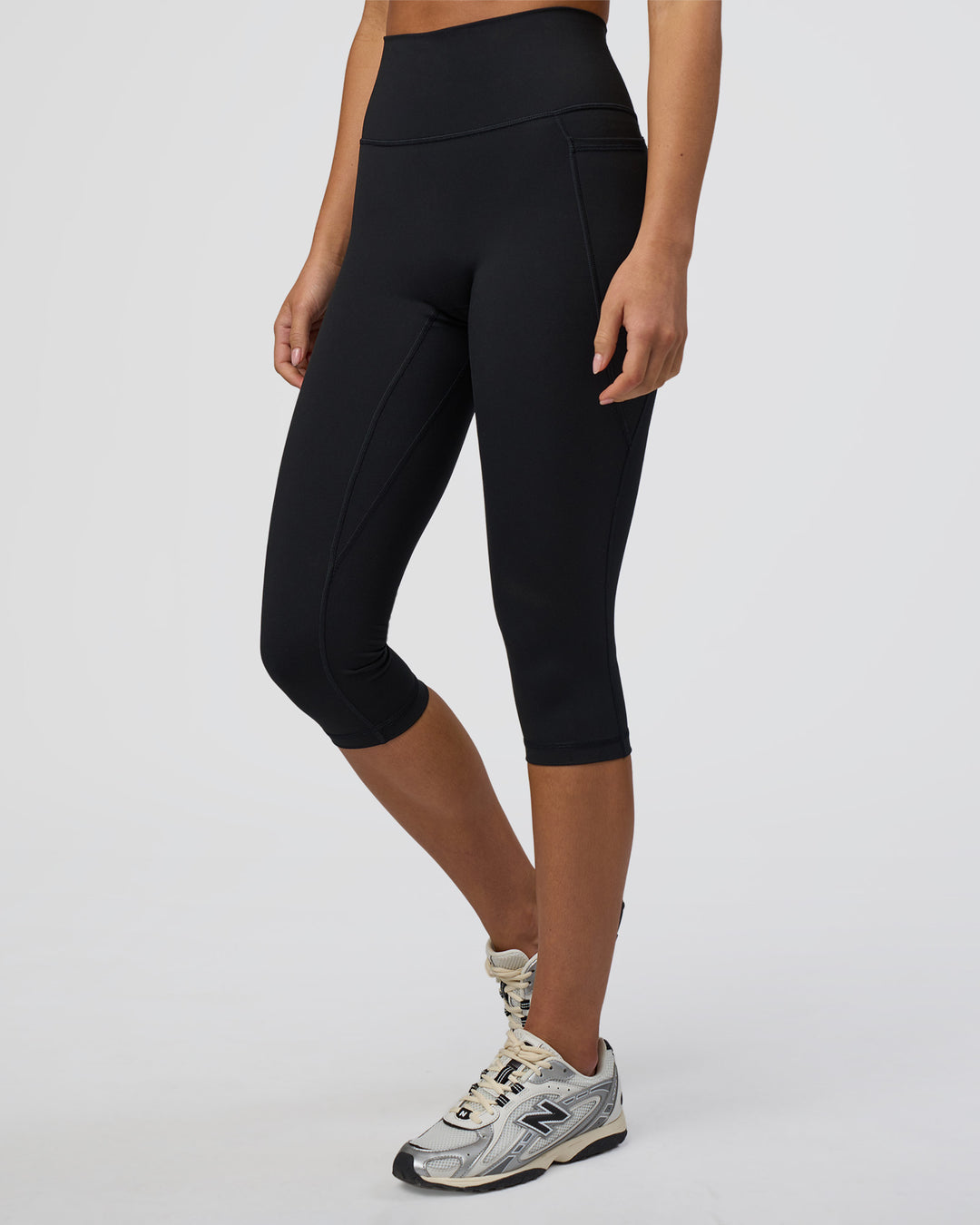 Woman wearing Fusion Ultra High-Rise 3/4 Legging Pockets - Black | Model:Eliza | Size:XS - view 2