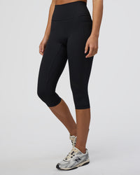 Woman wearing Fusion Ultra High-Rise 3/4 Legging Pockets - Black | Model:Eliza | Size:XS | Thumbnail Index: 1