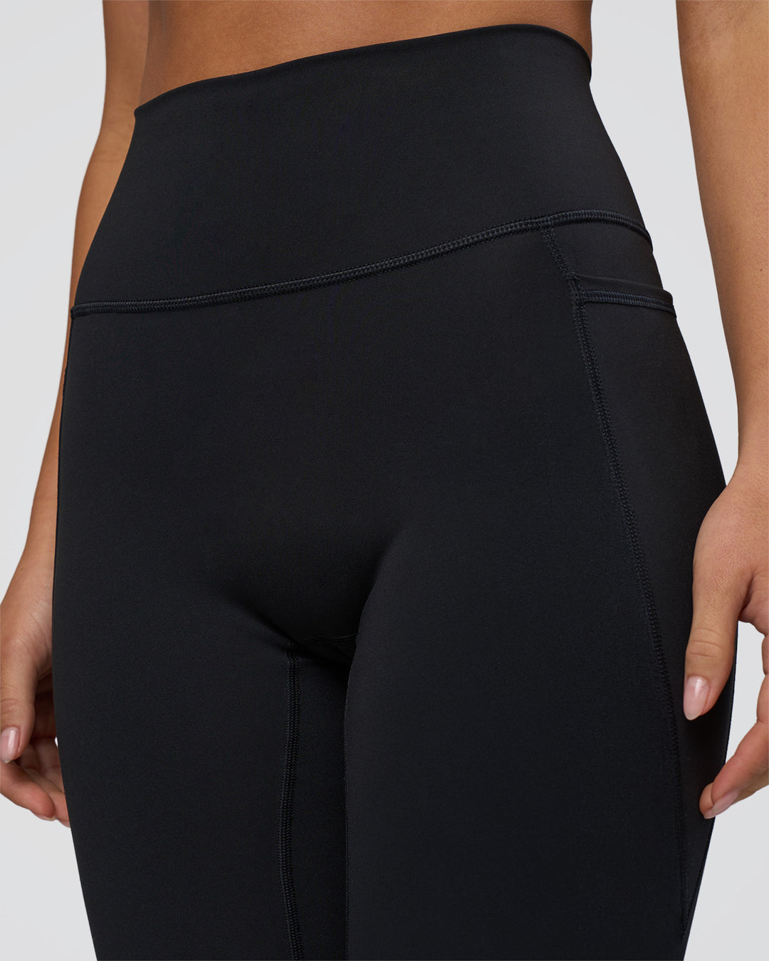 Woman wearing Fusion Ultra High-Rise 3/4 Legging Pockets - Black | Model:Eliza | Size:XS - view 8