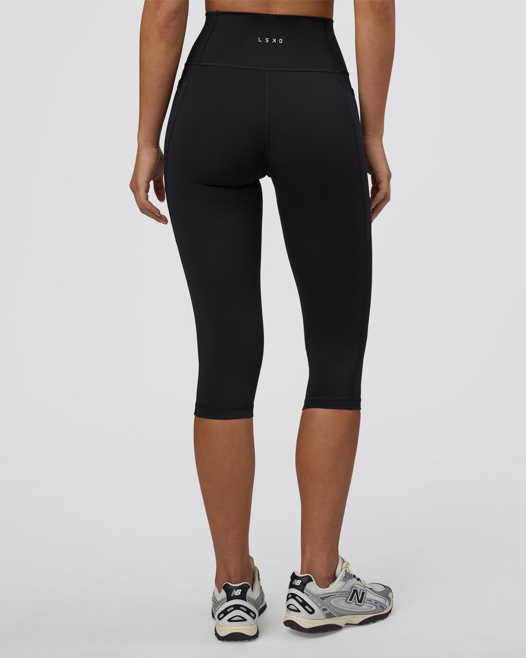 Woman wearing Fusion Ultra High-Rise 3/4 Legging Pockets - Black | Model:Eliza | Size:XS - view 3