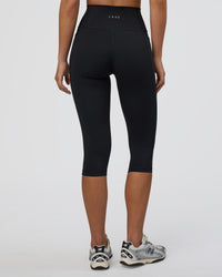 Woman wearing Fusion Ultra High-Rise 3/4 Legging Pockets - Black | Model:Eliza | Size:XS | Thumbnail Index: 2
