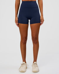 Woman wearing Fusion Ultra High-Rise 4" Short - Future Navy | Set:true | Angle:front | Model:Charli | Size:XS | Thumbnail Index: 1