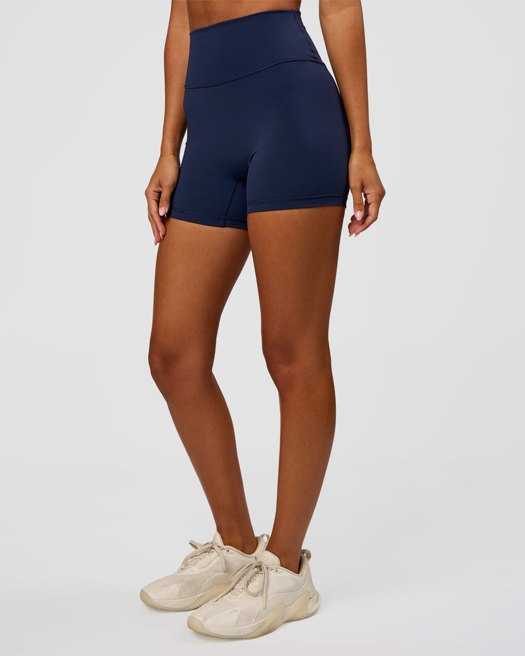 Woman wearing Fusion Ultra High-Rise 4" Short - Future Navy | Set:true | Angle:side | Model:Charli | Size:XS - view 1