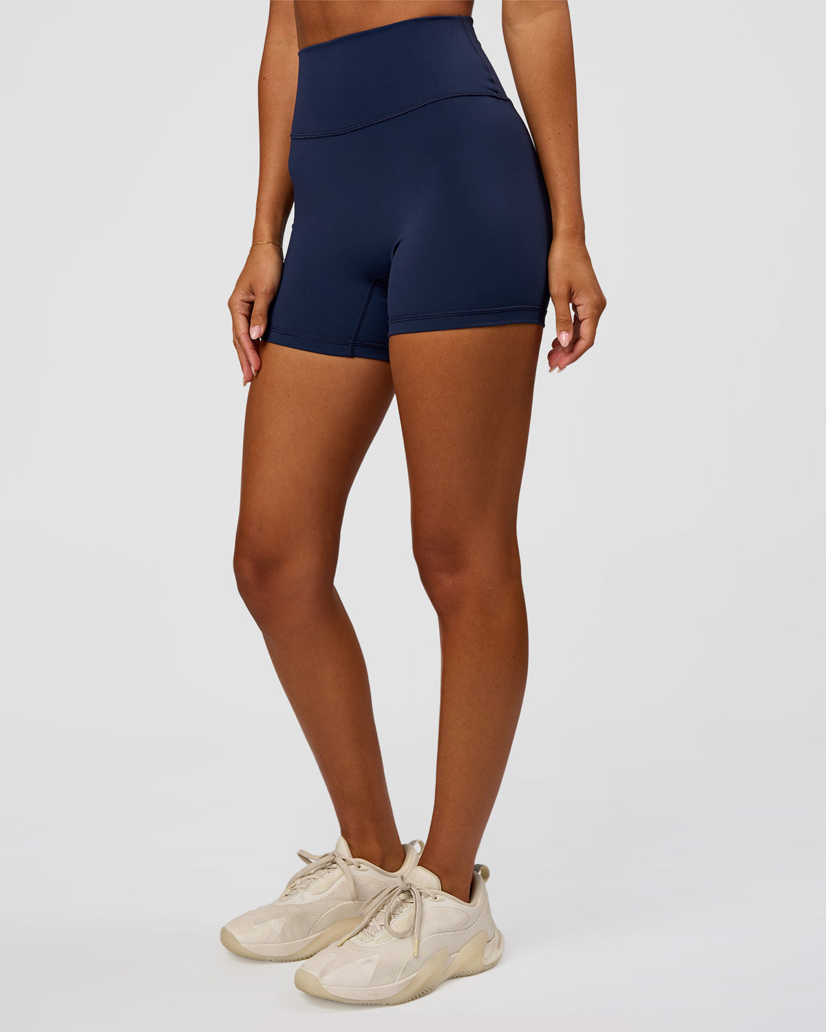 Woman wearing Fusion Ultra High-Rise 4" Short - Future Navy | Set:true | Angle:side | Model:Charli | Size:XS
