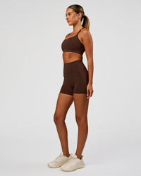 Woman wearing Fusion Ultra High-Rise 4" Short Pockets - Hot Chocolate | Model:Charli | Size:XS | Thumbnail Index: 8