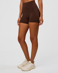 Woman wearing Fusion Ultra High-Rise 4" Short Pockets - Hot Chocolate | Set:true | Angle:side | Model:Charli | Size:XS | Thumbnail Index: 0