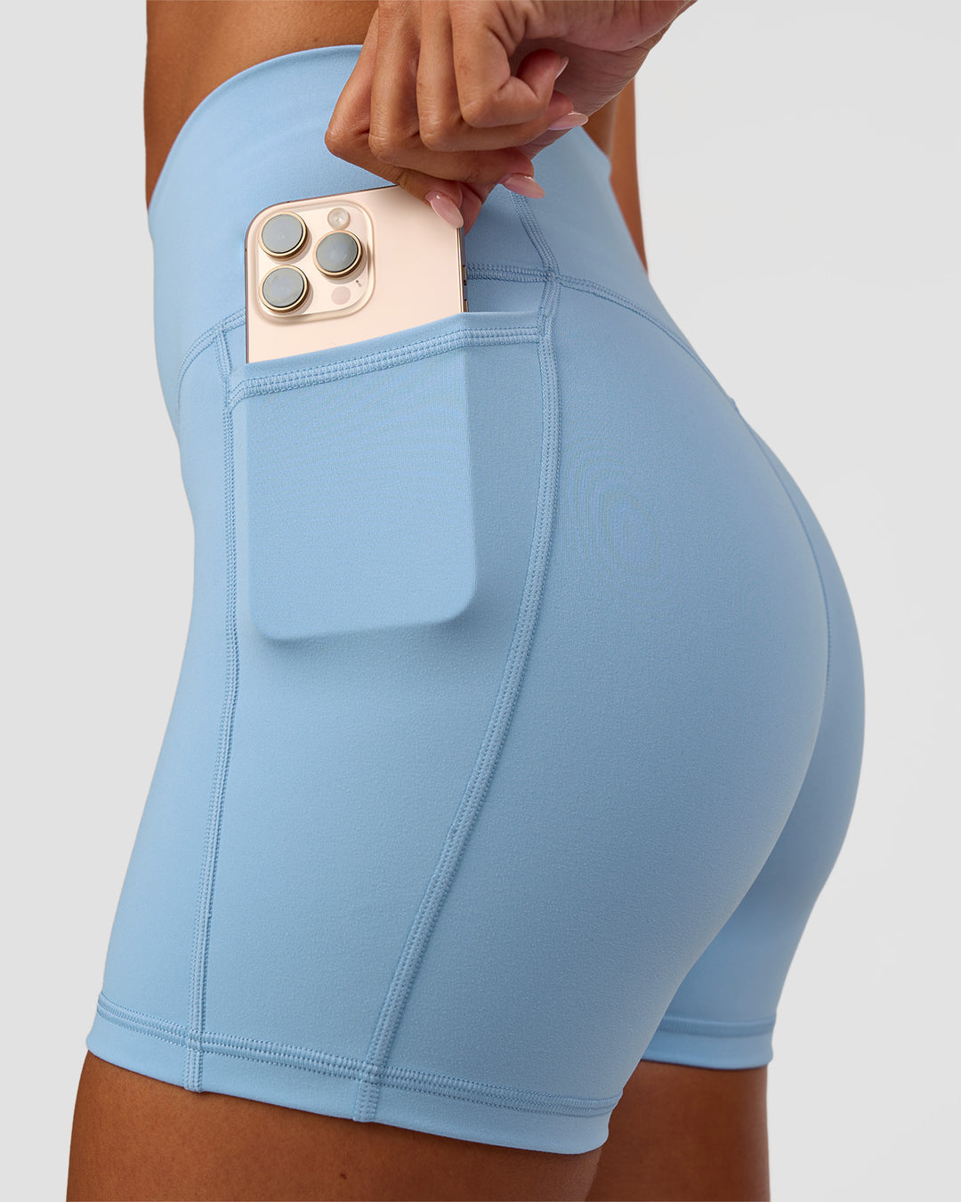 Woman wearing Fusion Ultra High-Rise 4" Short Pockets - Open Air | Set:true | Angle:closeup | Model:Charli | Size:XS - view 5