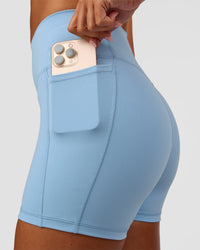 Woman wearing Fusion Ultra High-Rise 4" Short Pockets - Open Air | Set:true | Angle:closeup | Model:Charli | Size:XS | Thumbnail Index: 4