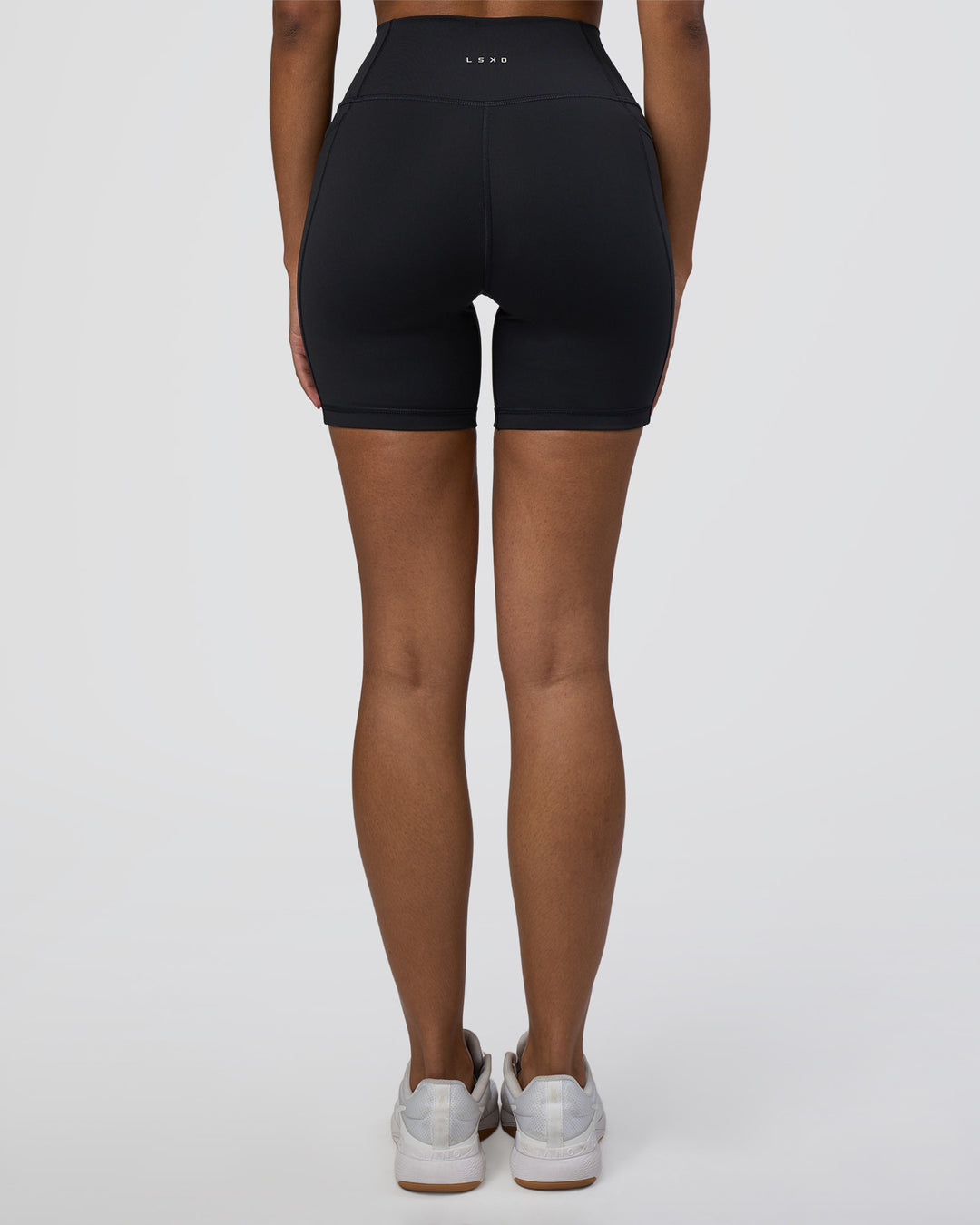 Woman wearing Fusion Ultra High-Rise 6" Short Pockets - Black | Set:true | Angle:back | Model:Jordan | Size:S - view 4