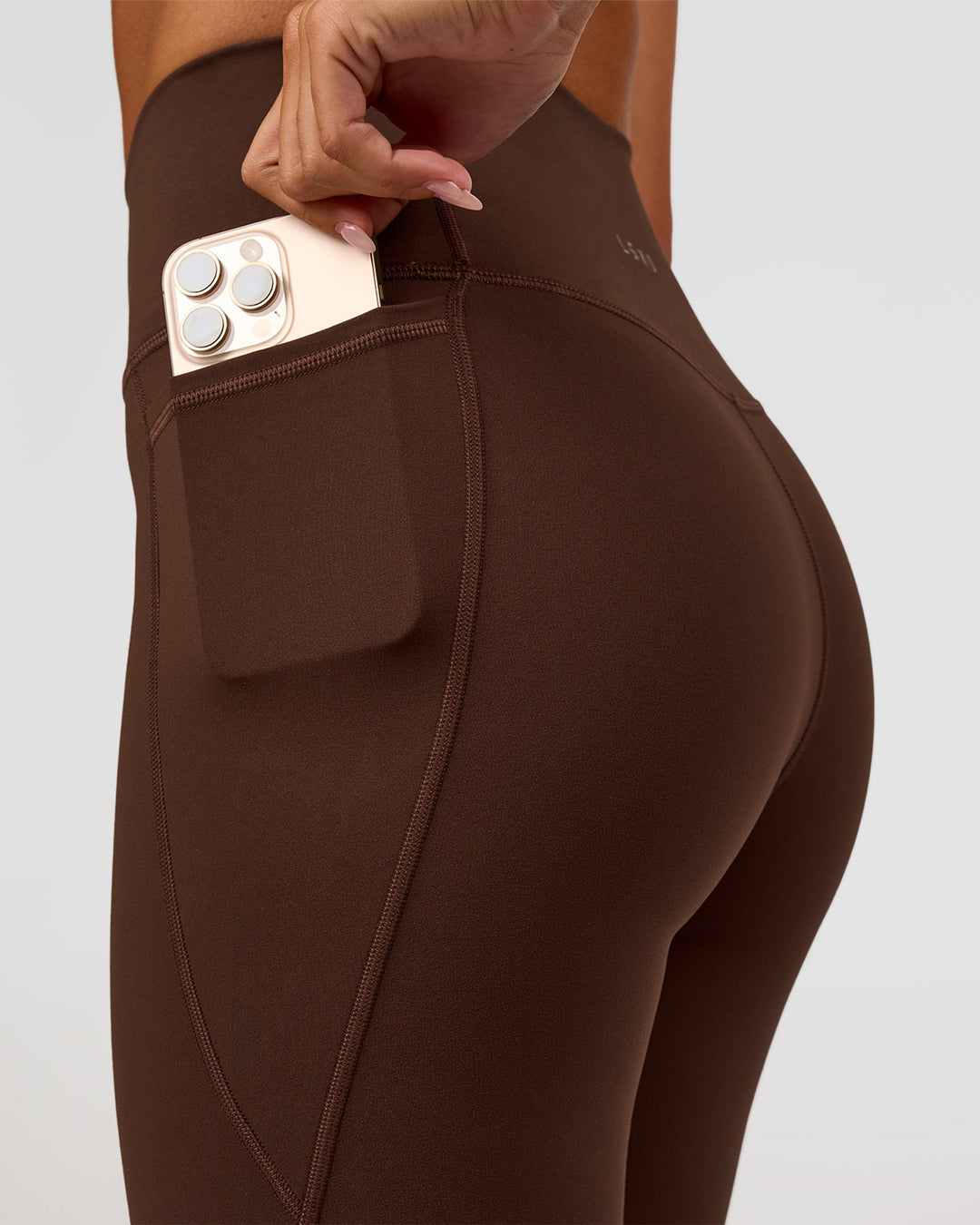Woman wearing Fusion Ultra High-Rise 9" Short Pockets - Hot Chocolate | Model:Charli | Size:XS - view 2