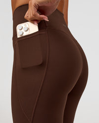 Woman wearing Fusion Ultra High-Rise 9" Short Pockets - Hot Chocolate | Model:Charli | Size:XS | Thumbnail Index: 1