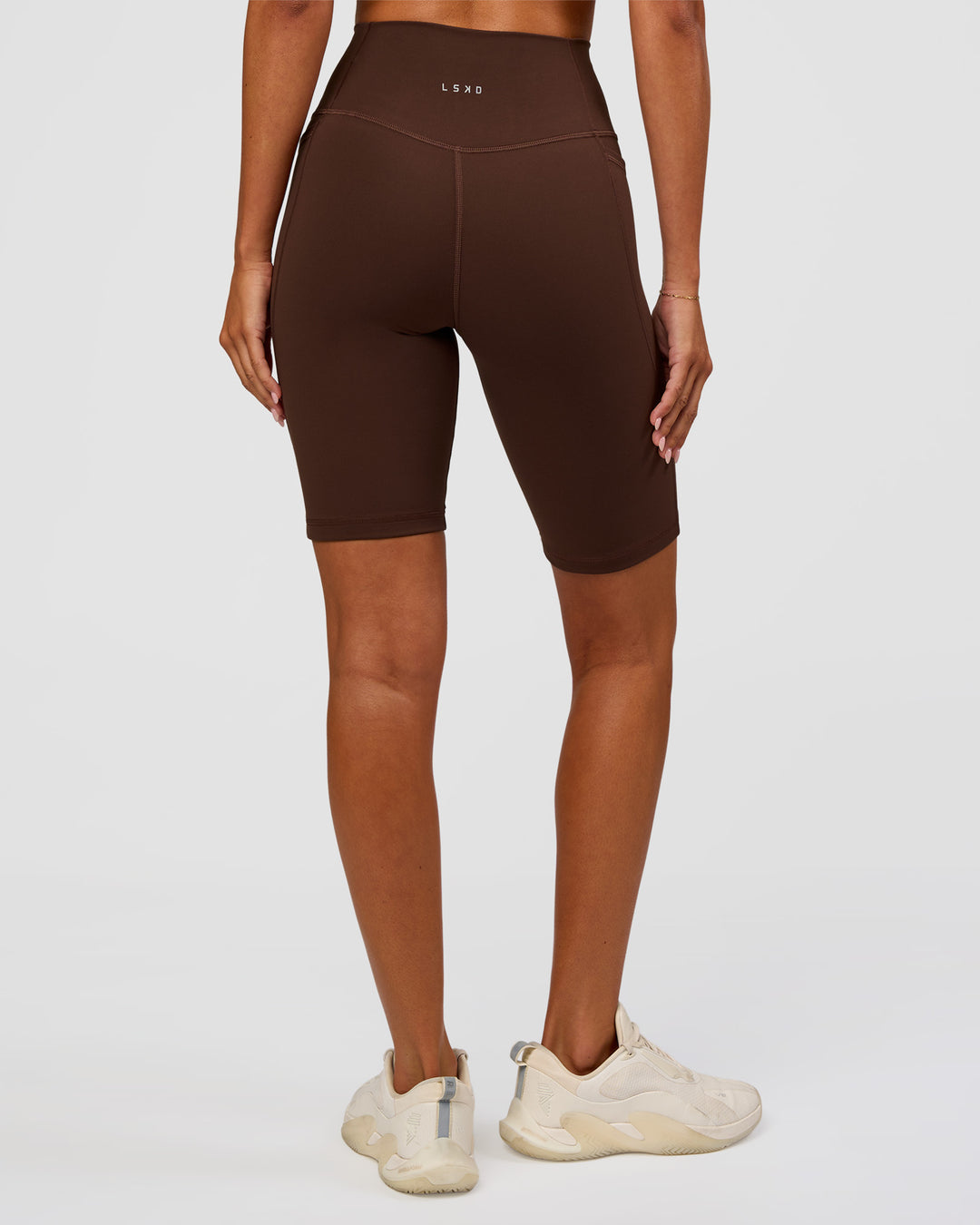 Woman wearing Fusion Ultra High-Rise 9" Short Pockets - Hot Chocolate | Model:Charli | Size:XS - view 4