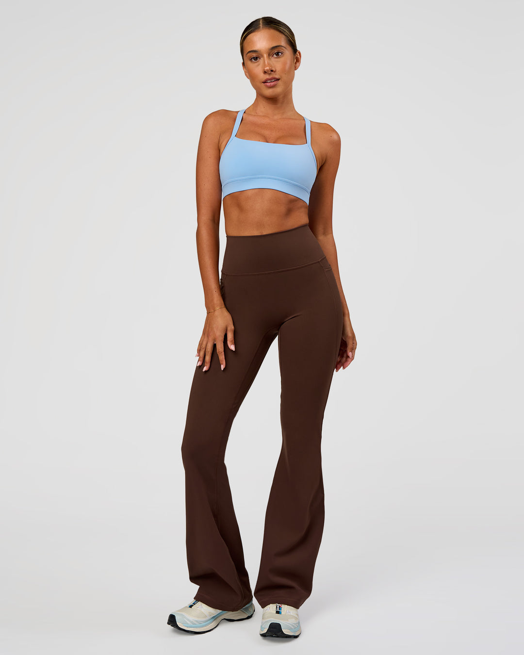Woman wearing Fusion Ultra High-Rise Flared Legging Pockets - Hot Chocolate | Model:Charli | Size:XS - view 7