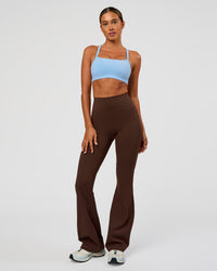 Woman wearing Fusion Ultra High-Rise Flared Legging Pockets - Hot Chocolate | Model:Charli | Size:XS | Thumbnail Index: 6