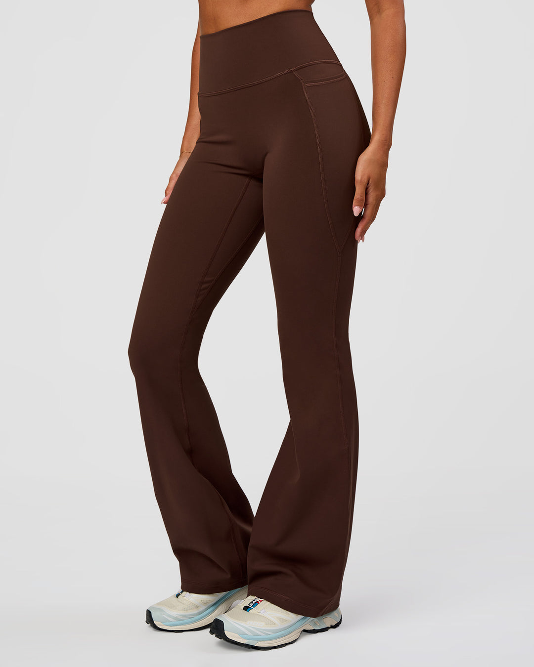Woman wearing Fusion Ultra High-Rise Flared Legging Pockets - Hot Chocolate | Model:Charli | Size:XS - view 1