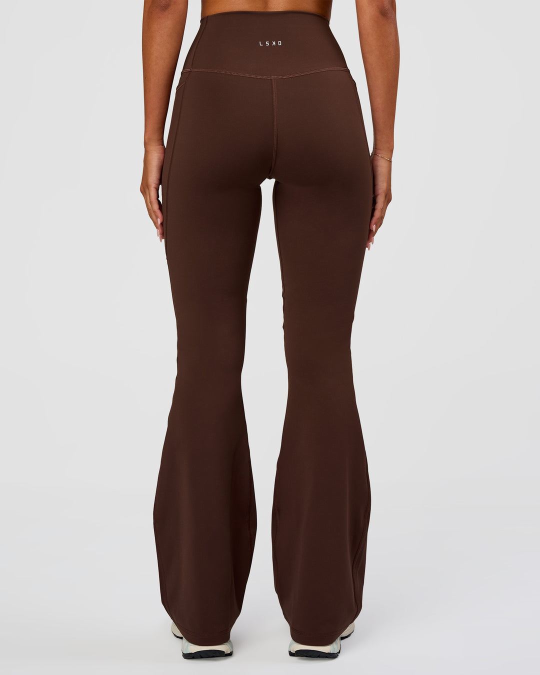 Woman wearing Fusion Ultra High-Rise Flared Legging Pockets - Hot Chocolate | Model:Charli | Size:XS - view 4