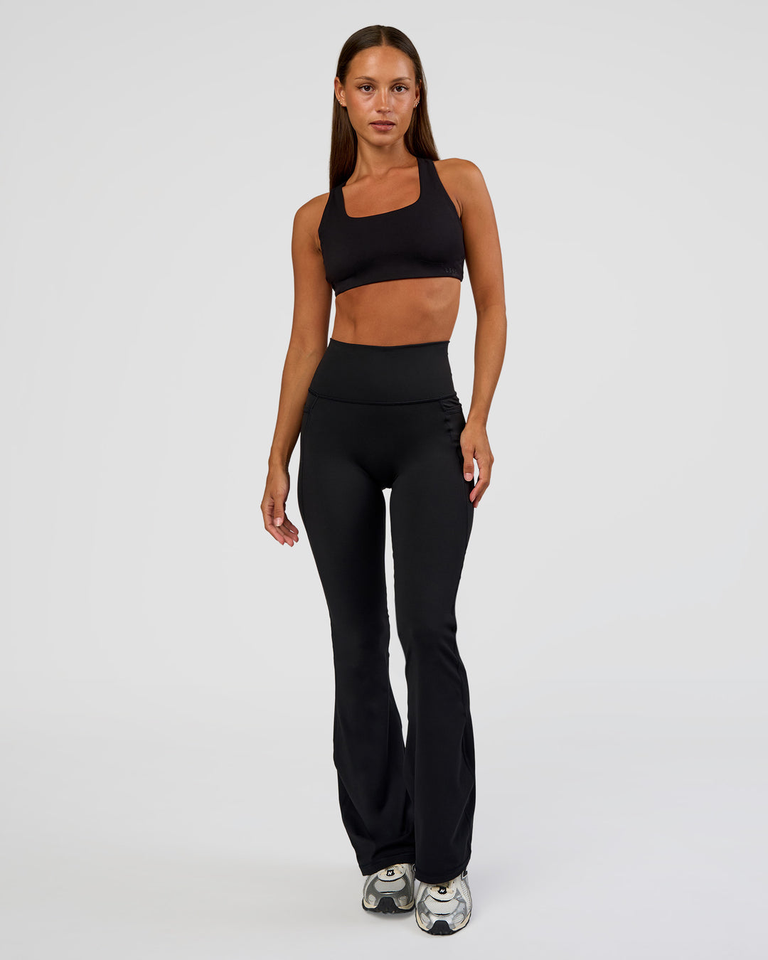 Woman wearing Fusion Ultra High-Rise Flared Petite Legging Pockets - Black | Model:Brylee | Size:XS - view 5