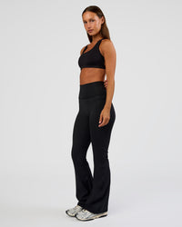 Woman wearing Fusion Ultra High-Rise Flared Petite Legging Pockets - Black | Model:Brylee | Size:XS | Thumbnail Index: 6