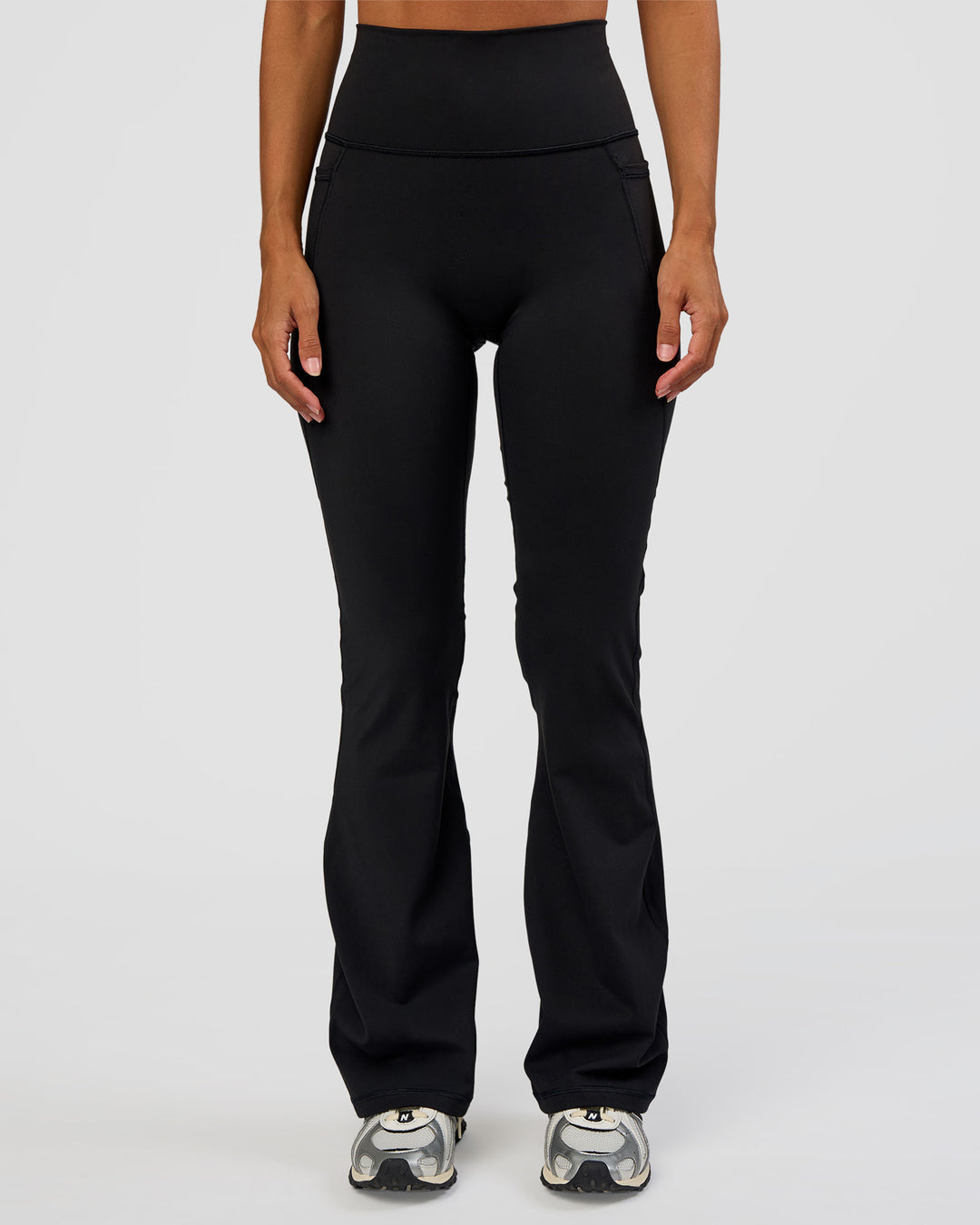 Woman wearing Fusion Ultra High-Rise Flared Petite Legging Pockets - Black | Model:Brylee | Size:XS - view 6