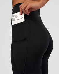Woman wearing Fusion Ultra High-Rise Flared Petite Legging Pockets - Black | Model:Brylee | Size:XS | Thumbnail Index: 3