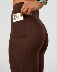 Woman wearing Fusion Ultra High-Rise Full Length Legging Pockets - Hot Chocolate | Model:Maja | Size:XS | Thumbnail Index: 3
