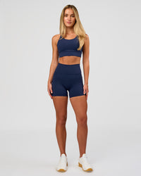 Woman wearing Fusion Ultra High-Rise 4" Short Pockets - Future Navy | Model:Issy | Size:XS | Thumbnail Index: 2
