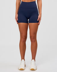 Woman wearing Fusion Ultra High-Rise 4" Short Pockets - Future Navy | Model:Issy | Size:XS | Thumbnail Index: 4
