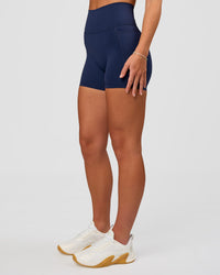 Woman wearing Fusion Ultra High-Rise 4" Short Pockets - Future Navy | Model:Issy | Size:XS | Thumbnail Index: 5