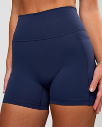 Woman wearing Fusion Ultra High-Rise 4" Short Pockets - Future Navy | Model:Issy | Size:XS | Thumbnail Index: 6