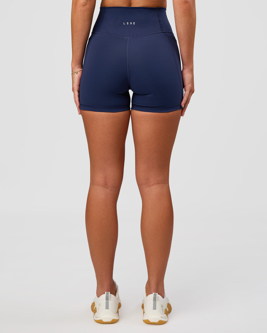Woman wearing Fusion Ultra High-Rise 4" Short Pockets - Future Navy | Model:Issy | Size:XS - view 2