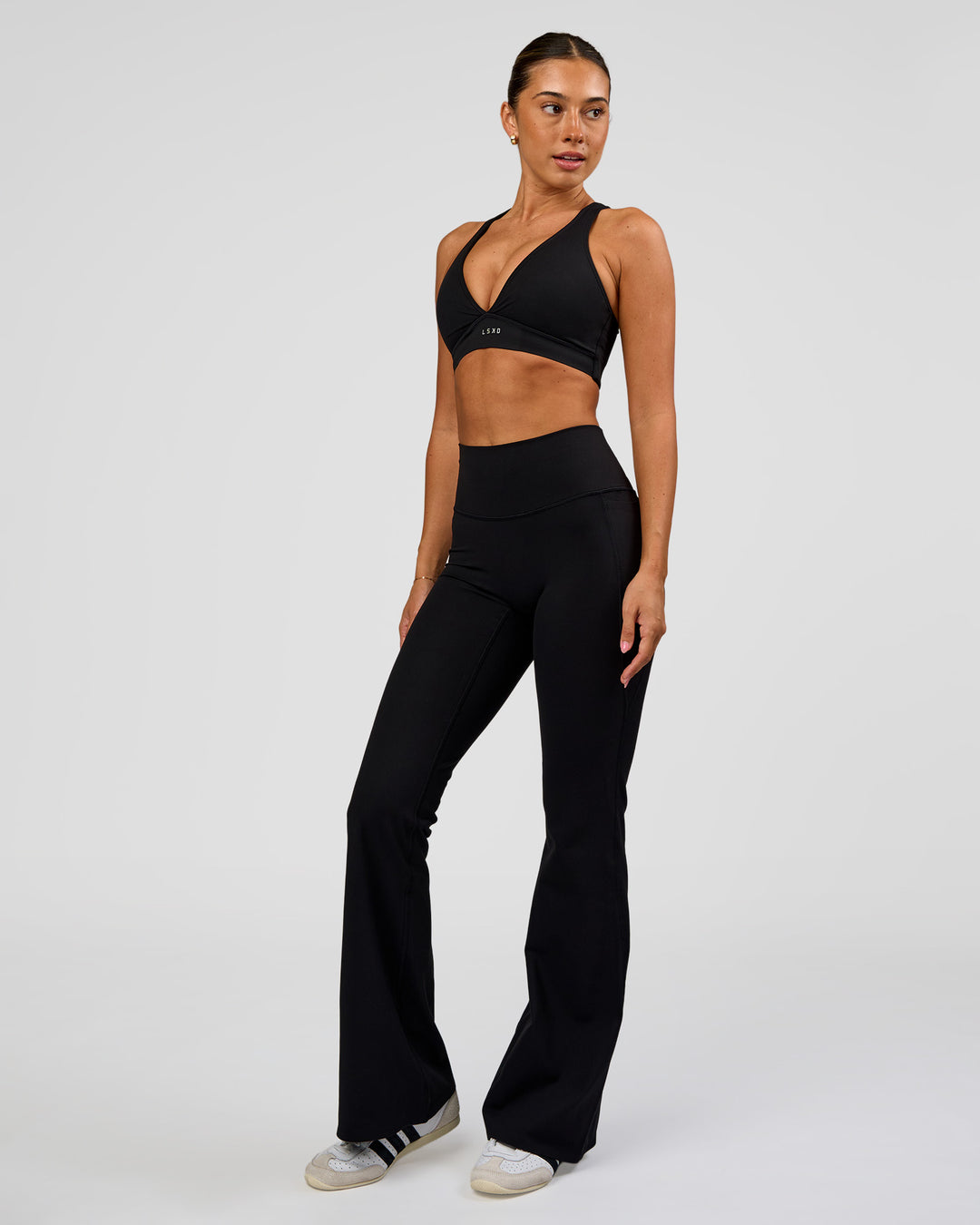 Woman wearing Fusion V-Contour High-Rise Flared Legging Pockets - Black | Model:Charli | Size:XS - view 5