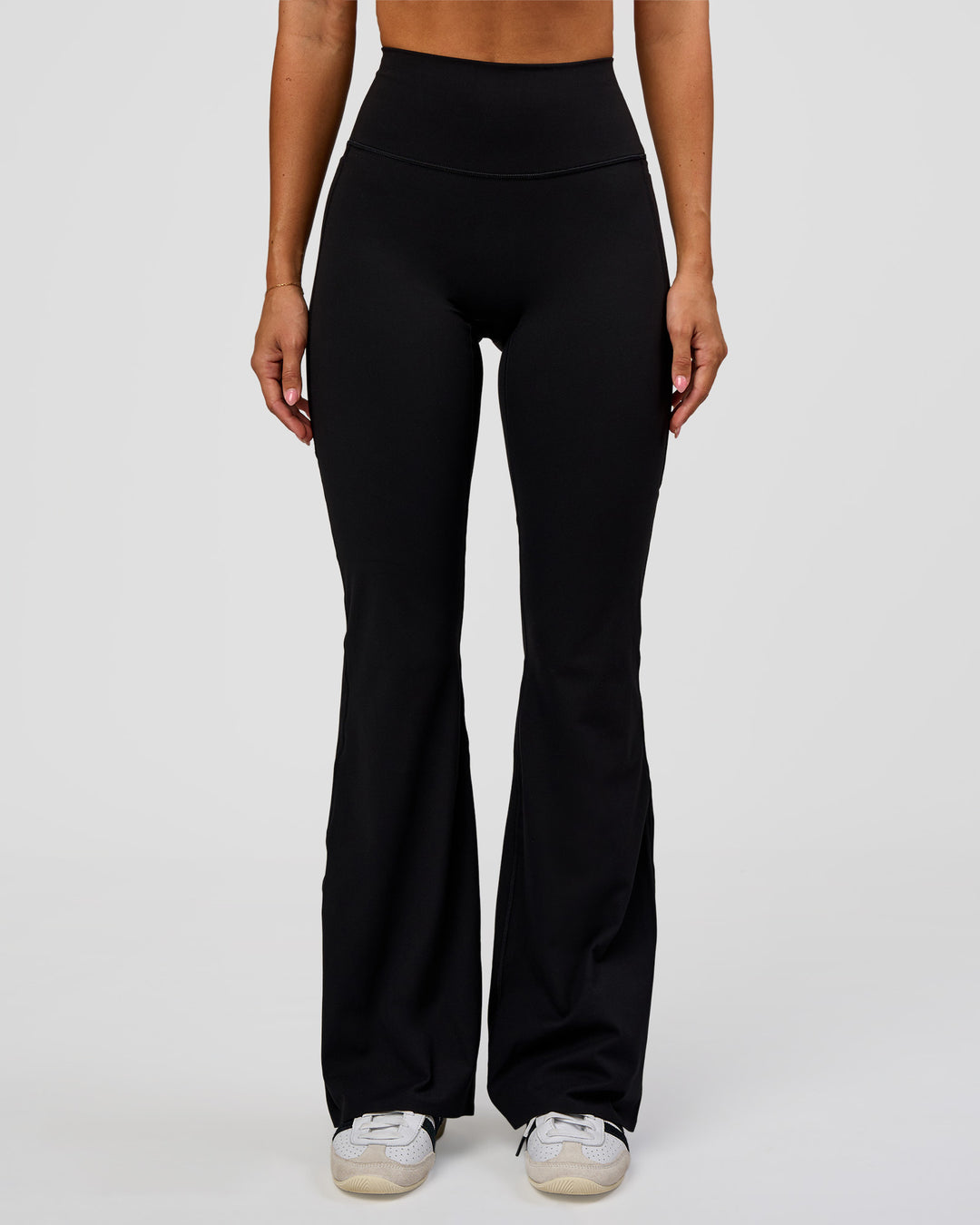Woman wearing Fusion V-Contour High-Rise Flared Legging Pockets - Black | Model:Charli | Size:XS - view 1