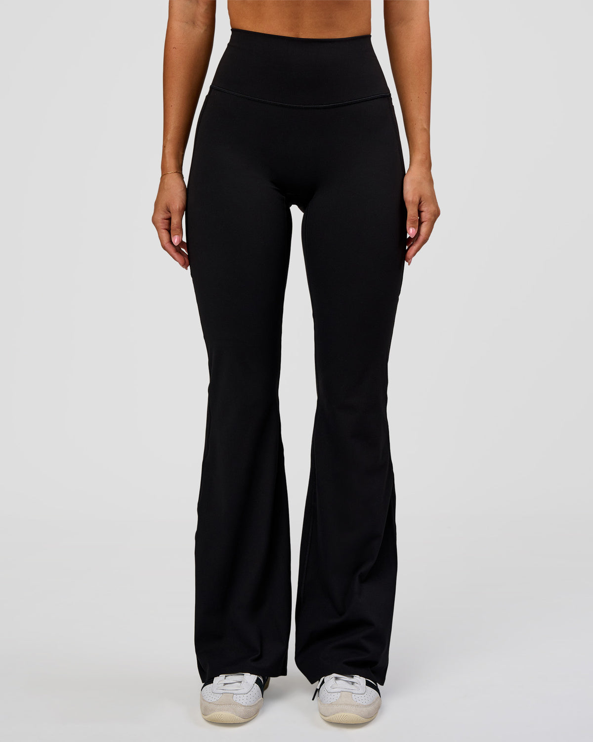 Woman wearing Fusion V-Contour High-Rise Flared Legging Pockets - Black | Model:Charli | Size:XS