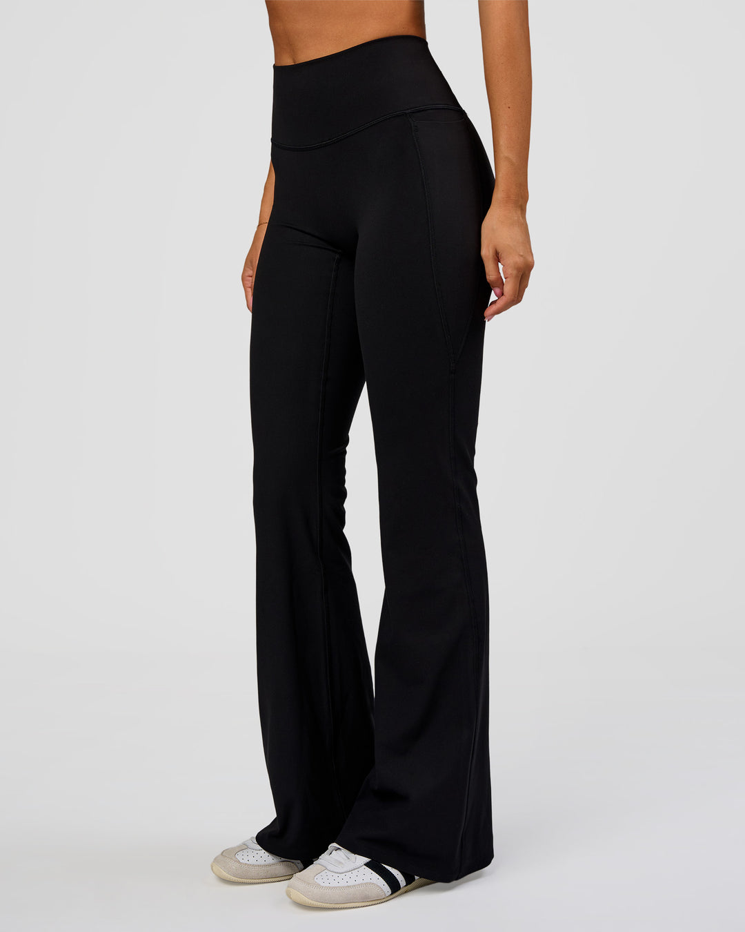 Woman wearing Fusion V-Contour High-Rise Flared Legging Pockets - Black | Model:Charli | Size:XS - view 6