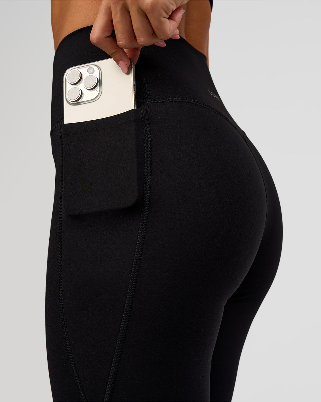 Woman wearing Fusion V-Contour High-Rise Flared Legging Pockets - Black | Model:Charli | Size:XS - view 2