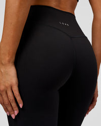 Woman wearing Fusion V-Contour High-Rise Flared Legging Pockets - Black | Model:Charli | Size:XS | Thumbnail Index: 3