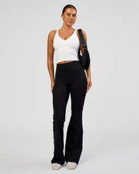 Woman wearing Fusion V-Contour High-Rise Flared Legging Pockets - Black | Model:Charli | Size:XS | Thumbnail Index: 7