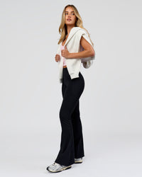 Woman wearing Fusion V-Contour High-Rise Flared Petite Legging Pockets - Black | Model:Issy | Size:XS | Thumbnail Index: 6
