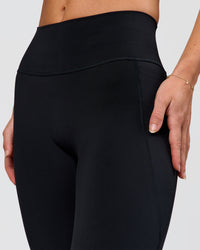 Woman wearing Fusion V-Contour High-Rise Flared Petite Legging Pockets - Black | Model:Issy | Size:XS | Thumbnail Index: 5