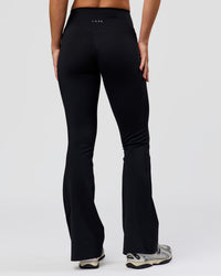 Woman wearing Fusion V-Contour High-Rise Flared Petite Legging Pockets - Black | Model:Issy | Size:XS | Thumbnail Index: 8