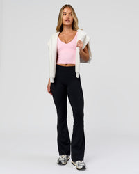 Woman wearing Fusion V-Contour High-Rise Flared Petite Legging Pockets - Black | Model:Issy | Size:XS | Thumbnail Index: 10