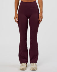 Woman wearing Fusion V-Contour High-Rise Flared Petite Legging Pockets - Cherry Lacquer | Model:Brylee | Size:XS | Thumbnail Index: 1