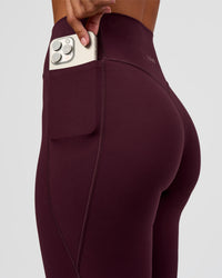 Woman wearing Fusion V-Contour High-Rise Flared Petite Legging Pockets - Cherry Lacquer | Model:Brylee | Size:XS | Thumbnail Index: 4