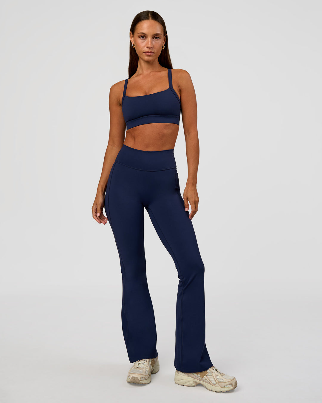 Woman wearing Fusion V-Contour High-Rise Flared Petite Legging Pockets - Future Navy | Model:Brylee | Size:XS - view 1