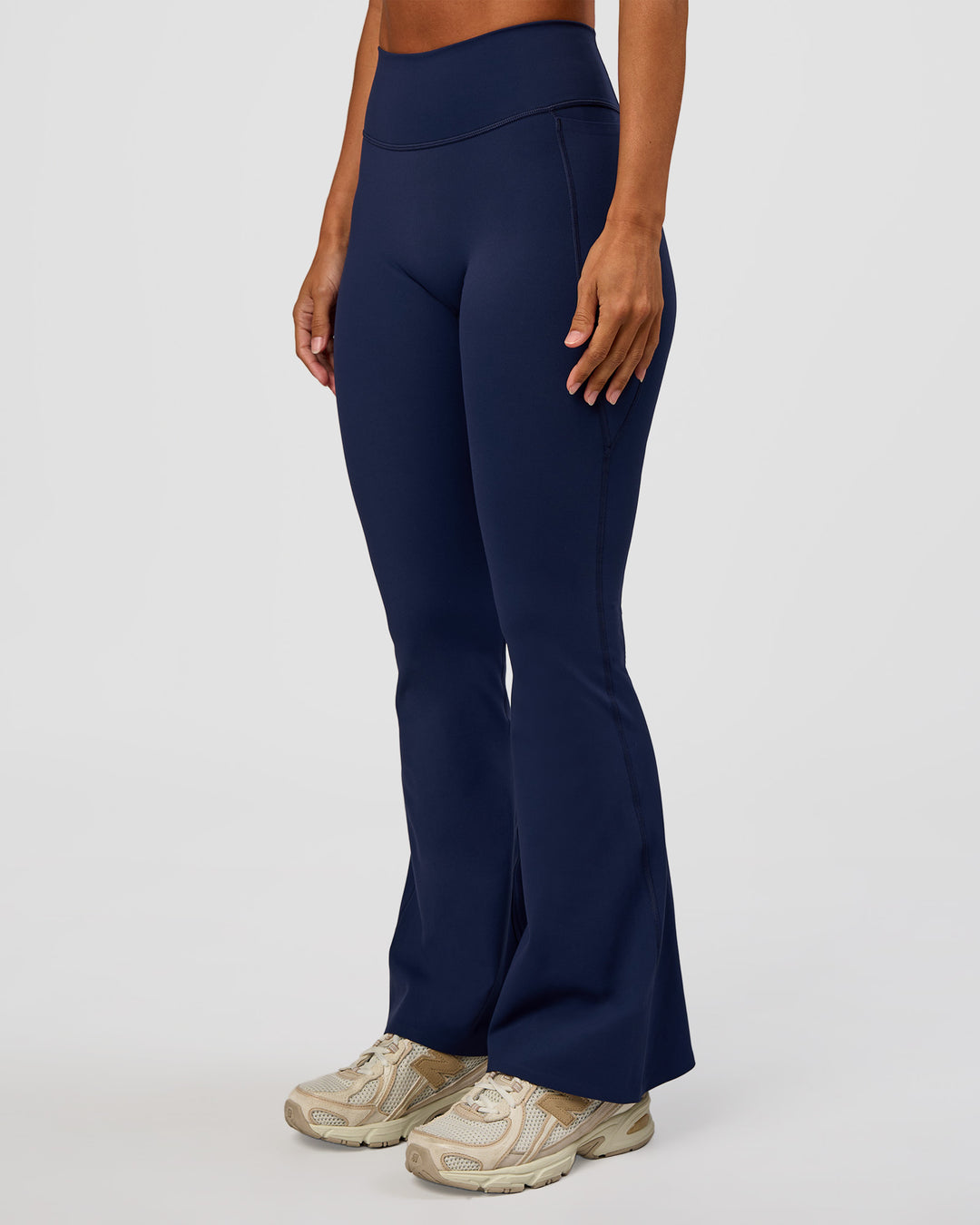 Woman wearing Fusion V-Contour High-Rise Flared Petite Legging Pockets - Future Navy | Model:Brylee | Size:XS - view 7