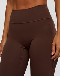 Woman wearing Fusion V-Contour High-Rise Flared Petite Legging Pockets - Hot Chocolate | Model:Brylee | Size:XS | Thumbnail Index: 7